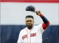  ??  ?? Boston Red Sox’s David Ortiz tips his cap to the crowd during ceremonies before Sunday’s game against the Toronto Blue Jays in Boston. The retiring 40-year-old DH really wants one more ring.