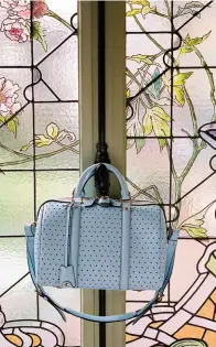  ??  ?? A soft periwinkle blue Louis Vuitton SC bag with perforated detailing