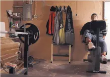  ?? ANTONIO PEREZ/CHICAGO TRIBUNE ?? Rafael Zuniga works out on a stationary bike in the basement of his home in Blue Island, Ill.