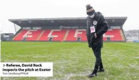  ?? Tom Sandberg/PPAUK ?? Referee, David Rock inspects the pitch at Exeter