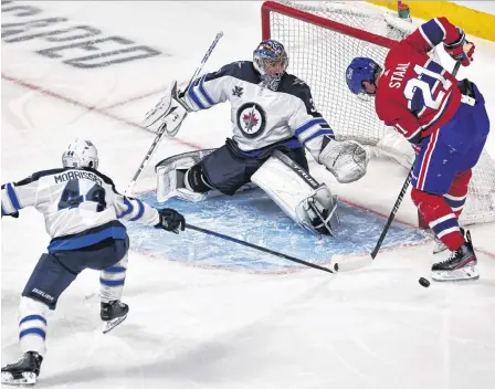  ?? USA TODAY SPORTS FILE PHOTO ?? Winnipeg Jets goalie Connor Hellebuyck — shown making a save against Montreal Canadiens’ Eric Staal (21) earlier this season — was once a familiar face to St. John’s hockey fans. He was an AHL all-star during his last year as a St. John’s Icecap. The Jets face the Canadiens in Game 1 of NHL’S North Division final tonight.