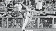  ?? [AP PHOTO] ?? Los Angeles Dodgers’ Charlie Culberson celebrates after a home run against the Houston Astros during the 11th inning of Game 2 to cut the Astros’ lead to 7-6. But that is the way the game ended as the Astros tied the World Series at 1-1 heading to...