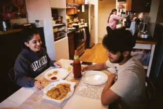  ?? Samantha Laurey / The Chronicle ?? Deepasha Debnath, 24, and her brother, Akshat, in the kitchen of their Cupertino home.