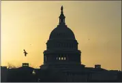  ?? CAROLYN KASTER, FILE - THE ASSOCIATED PRESS ?? In this March 4 photo, a bird flies near the U.S. Capitol dome at sunrise in Washington. The Republican fundraisin­g committee dedicated to flipping the House in the 2022 midterm elections says it raised more than $105 million this year through September 2021. The record haul marks a 74% increase over last cycle and includes $25.8 million raised in the third quarter of the year.