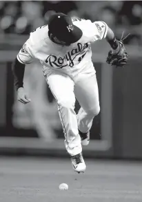  ?? Associated Press ?? Kansas City Royals second baseman Whit Merrifield tries to barehand a ball bunted by Minnesota Twins' Logan Schafer during the fifth inning of a baseball game Thursday at Kauffman Stadium in Kansas City, Mo. Merrifield dropped the ball and Schafer was...