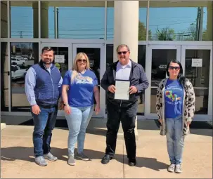  ?? Special to The Saline Courier ?? Benton Mayor Tom Farmer, center right, shares his proclamati­on of April as Autism Awareness Month and April 2 as World Autism Awareness Day.