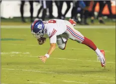  ?? Rich Schultz / Associated Press ?? The New York Giants’ Daniel Jones loses his balance and falls after he runs for an 80- yard gain during the third quarter against the Philadelph­ia Eagles on Thursday night in Philadelph­ia. The play exemplifie­d everything that is wrong with play in the NFC East.