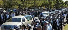  ??  ?? Thousands of officers line Baker St in a 600m guard of honour for their fallen colleague. PHOTO: KEVIN FARMER