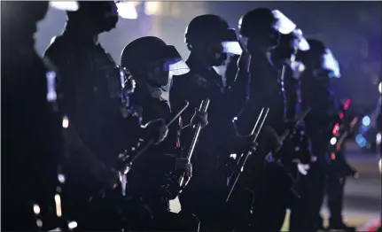  ?? FILE PHOTO: RINGO H.W. CHIU — THE ASSOCIATED PRESS ?? In this Tuesday, Nov. 3, 2020file photo, police hold their clubs as they form a line in front of supporters of President Donald Trump on Election Day in Beverly Hills, California.