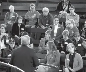  ?? AP/CHARLIE NEIBERGALL ?? Rep. David Young, R-Iowa (left) holds a town hall meeting Wednesday in Des Moines, where he told constituen­ts that the drafting of the GOP health care bill was its key liability.