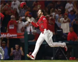  ?? RONALD MARTINEZ — GETTY IMAGES ?? The Angels' Taylor Ward celebrates after hitting a walkoff, two-run home run against the Minnesota Twins in the 11th inning on Saturday night at Angel Stadium.