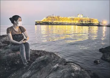  ?? Paula Bronstein Getty Images ?? THE WESTERDAM cruise ship of the Holland America Line floats off Sihanoukvi­lle, Cambodia, after it had been at sea for two weeks and turned away by ports in at least five countries over coronaviru­s concerns.