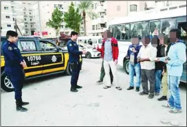  ?? ?? Police checking documents of expatriate­s in Mahboula.