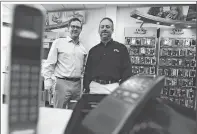  ?? DAY FILE PHOTO ?? Neil Ryan, left, and Scott Gladstone in 2014 at an earlier version of one of their Wireless Zone franchises, with a cellphone from 1992 shown in the foreground.