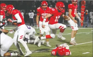  ?? DAVID WITTE/NEWS-SENTINEL ?? Lodi quarterbac­k Adam Schallberg­er (10) hurdles over a teammate on his way to a 27-yard touchdown during Lodi's victory over Tokay on Friday at Hubbard Field.