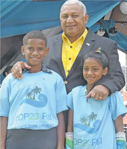  ?? Photo: DEPTFO News ?? Prime Minister Voreqe Bainimaram­a with climate ambassador­s Timoci Naulusala and Shalvi Shakshi during the National Climate Day at Ratu Sukuna Park in Suva on November 6, 2018.