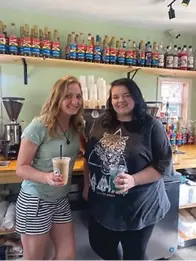  ?? ?? Owner Jennifer Wittman, left, and barista Elizabeth Wall pose with their drinks on Wednesday inside Roosters Coffee Co. in Texarkana, Texas. (Staff photo by Sharda James)