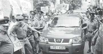  ??  ?? A car transporti­ng the remains of Thajudeen leaves the burial ground of the Dehiwela mosque in Colombo after the body was exhumed to be sent to the Judicial Medical Officer. — AFP photo