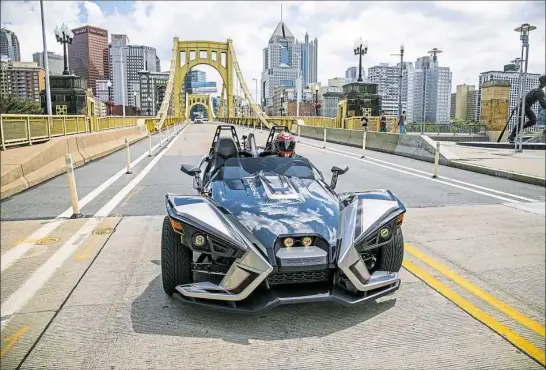  ?? Andrew Rush/Post-Gazette ?? The three-wheeled Polaris Slingshot SLR crosses the Roberto Clemente Bridge near PNC Park. See video at post-gazette.com.