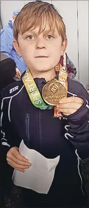  ?? ?? A steller performanc­e: Mason Beattie with his bronze medal.