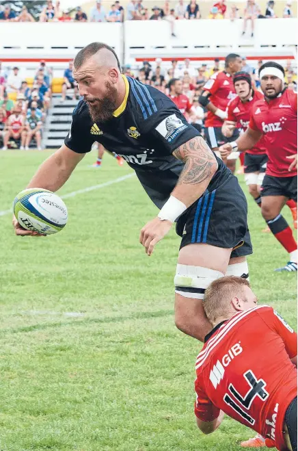  ?? Photo: LOREN DOUGAN/FAIRFAX NZ ?? Blade runner: Hurricanes loose forward Blade Thomson looks to offload in the tackle of Crusaders wing Johnny McNicholl during a Super Rugby pre-season match in Eketahuna on Saturday.
