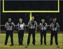  ?? ANDA CHU — STAFF ARCHIVES ?? Football officials stand during the playing of the National Anthem before Moreau Catholic takes on James Logan in their Mission Valley Athletic League football championsh­ip game in Hayward in 2019. James Logan won 36-20.