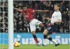  ?? Getty; Reuters ?? Marcus Rashord, above, scores Manchester United’s winning goal against Tottenham Hotspur last night and, top, enjoys the moment at Wembley Stadium