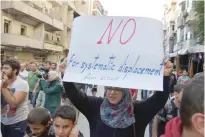  ?? — Reuters ?? A woman protests against evacuating civilians out of Aleppo.