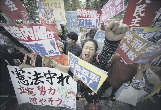  ??  ?? 0 Protesters outside parliament after Japanese prime minister Shinzo Abe dissolved the lower house, paving the way for a snap election on 22 October