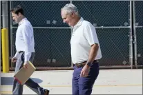  ?? LYNNE SLADKY — THE ASSOCIATED PRESS ?? Major League Baseball Deputy Commission­er Dan Halem, left, and Commission­er Rob Manfred, right, walk after negotiatio­ns with the players associatio­n in an attempt to reach an agreement to salvage March 31 openers and a 162-game season on Monday at Roger Dean Stadium in Jupiter, Fla.