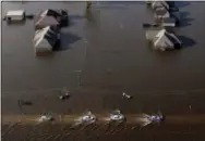  ?? THE ASSOCIATED PRESS ?? Cars drive through flooded streets from Tropical Storm Harvey in Orange, Texas, on Thursday.