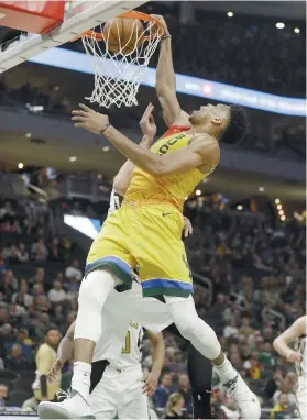  ?? AP FOTO ?? IN YOUR FACE. Milwaukee Bucks star Giannis Antetokoun­mpo throws down an emphatic dunk over Atlanta Hawks center Alex Len.