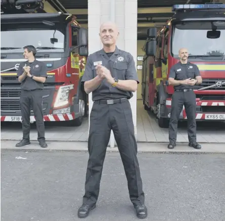  ??  ?? 0 Community spirit: firefighte­rs in Falkirk clap for NHS workers, carers and other essential workers