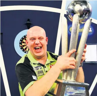  ??  ?? GRIP HIP HOORAY Beaming van Gerwen lifts the trophy after romping to glory with world-class show