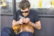  ?? Gabrielle Lurie / The Chronicle 2019 ?? A man smokes fentanyl on Turk Street in S.F. Drug overdose deaths in the city are rising to new highs.