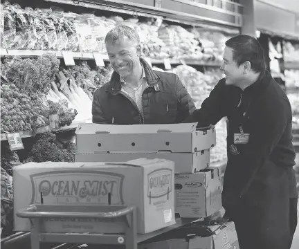  ?? JULIE OLIVER ?? Farm Boy CEO Jean Louis Bellemare shares a laugh with produce supervisor Jhames Lazo at the store on McRae Avenue.