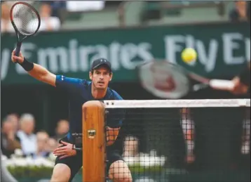  ?? The Associated Press ?? EYE ON THE BALL: Britain’s Andy Murray, left, eyes the ball as Argentina’s Juan Martin del Potro volleys during their third-round match of the French Open at the Roland Garros stadium Saturday in Paris. Murray won 7-6, 7-5, 6-0.