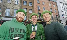  ?? ?? Germans Robert Eyner, Maximilian Lachmann and Gregor Beuthner enjoy a drink at the Dublin parade.