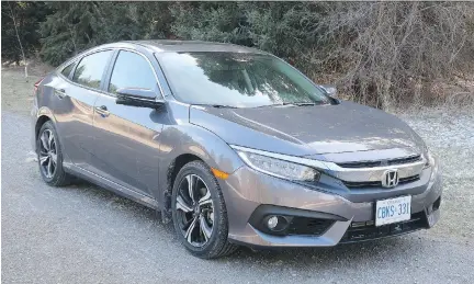  ?? JIL MCINTOSH/DRIVING ?? The 2017 Honda Civic Touring sedan is no corner-carving sports car, but it’s an impressive and fun ride at a reasonable price.