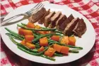  ?? LINDA GASSENHEIM­ER/TNS ?? Sweet and Spicy Pork, with Roasted Butternut Squash and Green Beans, combines the sweet flavor of cinnamon with a touch of cayenne pepper for spice.