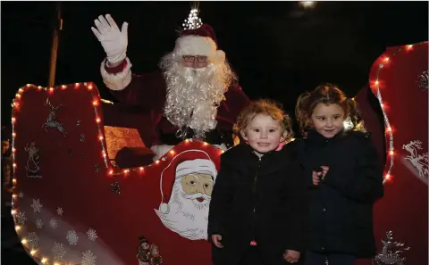  ??  ?? Skye and Jolene McMahon meet Santa Claus after his arrival in Newtown to switch on the Christmas lights.