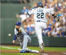  ?? Stephen Brashear Associated Press ?? A STRETCH by Dodgers first baseman Max Muncy isn’t enough to nab Seattle’s Robinson Cano, who races for an infield single in the first inning Saturday.