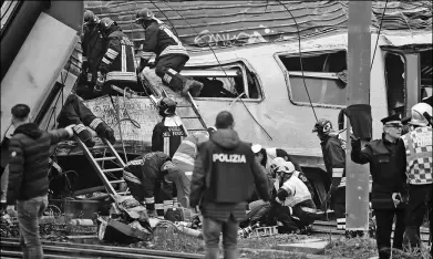  ?? PROVIDED BY REUTERS ?? Firefighte­rs and police officers work around derailed trains in Pioltello, on the outskirts of Milan, Italy, on Thursday. The accident killed at least three people, seriously injured 10 and trapping others heading into Milan at the start of the work...