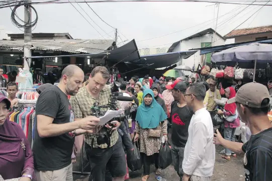  ?? GAVIN SEAL ?? Montreal producer Nabil Mehchi, left, director Van Royko and artist Ari Bayuaji on the scene in Jakarta for their CBC documentar­y series Interrupt This Program.