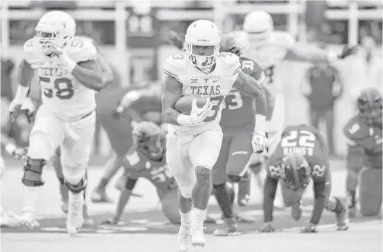  ?? John Weast / Getty Images ?? Texas running back D’Onta Foreman set career highs with 341 yards rushing and three touchdowns during the Longhorns’ victory at Texas Tech on Saturday.