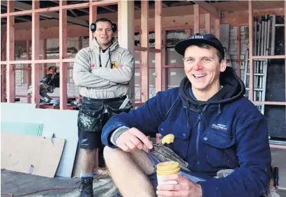  ?? PHOTO: STEPHEN JAQUIERY ?? Food of champions . . . Mark (rear) and Michael Hastie from Bay Road take a break while fitting out the inside of their new premises.