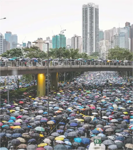  ?? CHRIS MCGRaTH/GETTY IMAGES ?? Thousands of anti-government protesters pack roadways after leaving a rally in Victoria Park in Hong Kong on Sunday. Pro-democracy protesters have continued to rally in the streets of Hong Kong since June in opposition to a controvers­ial extraditio­n bill.