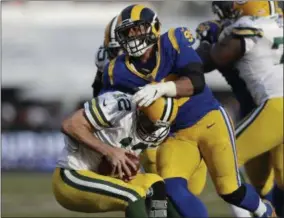  ?? MARCIO JOSE SANCHEZ - THE ASSOCIATED PRESS ?? Los Angeles Rams defensive tackle Aaron Donald, above, sacks Green Bay Packers quarterbac­k Aaron Rodgers, below, during the second half of an NFL football game, Sunday, Oct. 28, 2018, in Los Angeles.