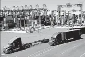  ?? MARCIO JOSE SANCHEZ/AP ?? The economy kept its momentum in the July-September period. Above, trucks travel along a California loading dock.