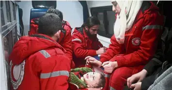  ?? — AFP ?? Emergency medical care: A wounded baby being evacuated in Douma in the Eastern Ghouta region on the outskirts of the capital Damascus.